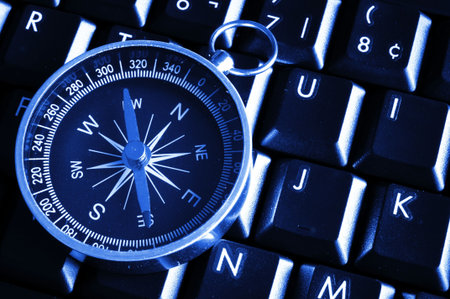 computer keyboard and compass showing internet navigation conceptの写真素材