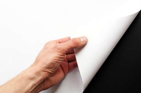 page or blank sheet of paper with hand and copyspace in the cornerの写真素材