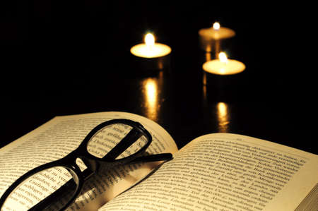 book candle and glasses with black copyspaceの写真素材