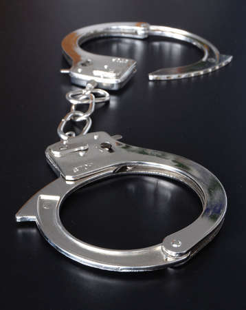 crime and law concept with police handcuffs on deskの写真素材