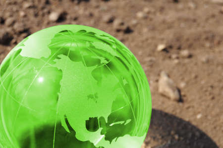 climate change concept with earth planet on dry soil and copyspaceの写真素材