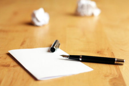 pen and paper in a wooden desktop showing creativity conceptの写真素材