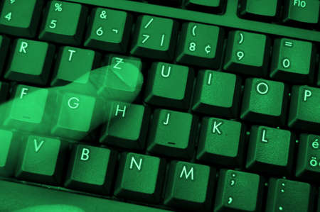 computer keyboard with ghost fingers at nightの写真素材