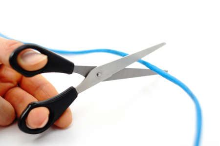 internet addiction concept with scissors and blue network cable on whiteの写真素材