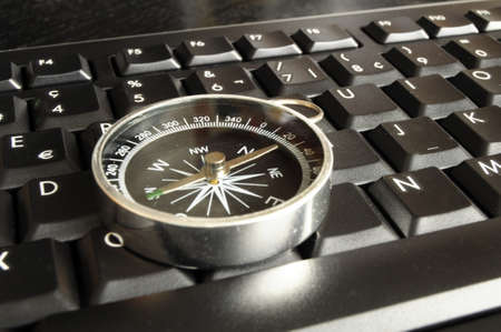 computer keyboard and compass showing internet navigation conceptの写真素材