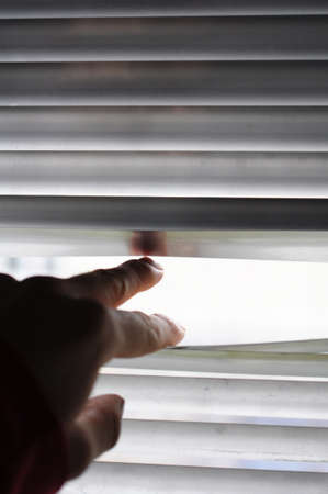 spy or observation concept with window and handの写真素材