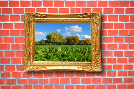 summer painting or picture in image frame on a wallの写真素材