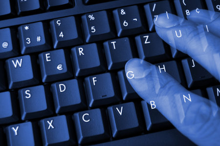 keyboard in black at night with hand and fingers showing internet concept