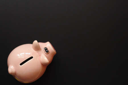 piggy bank and blank or empty black copyspaceの写真素材