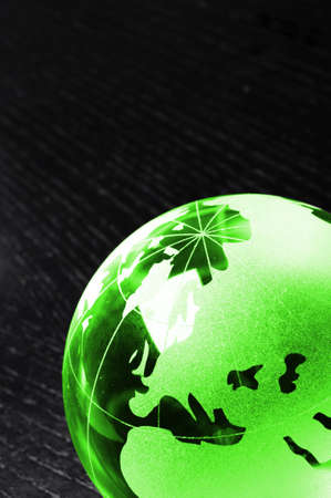 glass globe on black background showing business or environment concept with copyspaceの写真素材