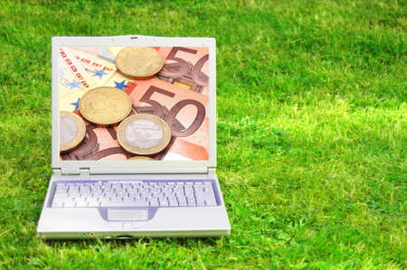 laptop and money showing electronic business or ecommerce conceptの写真素材