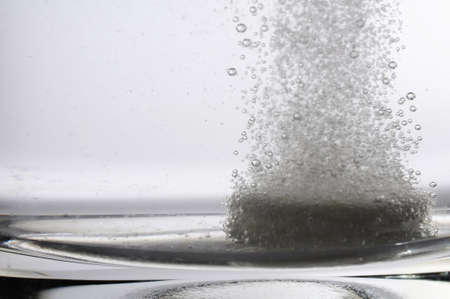 tablet or pills in glass of water showing medicine conceptの写真素材