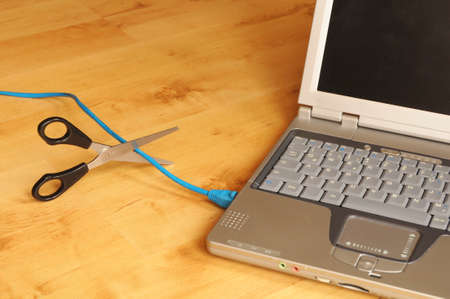 wireless network or wlan concept with laptopn scissors and cableの写真素材