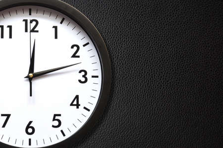 clock or watch on a wall with copyspace showing time conceptの写真素材