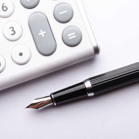 calculator showing business accounting concept in whiteの写真素材