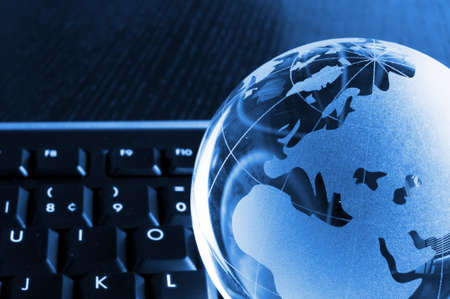 globalisation concept with glass planet on computer keyboard and copyspaceの写真素材