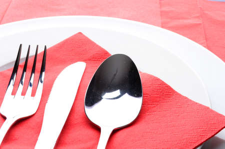 stainless fork knife and plate set on a tableの写真素材