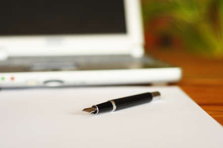 business desktop still life with folder pen copyspace and laptop in officeの写真素材