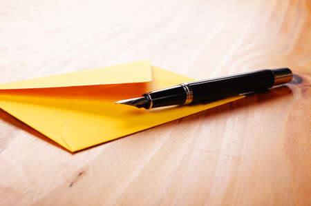 envelop and pen showing mail or communication conceptの写真素材