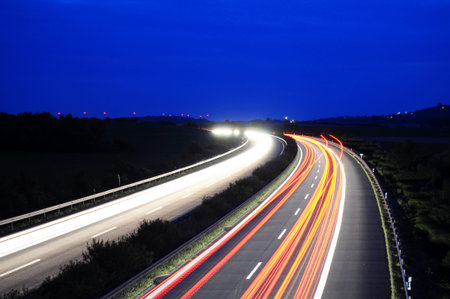 night traffic motion blur on highway showing car or transportation conceptの写真素材