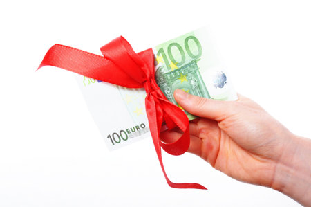 euro money with red ribbon showing gift conceptの写真素材