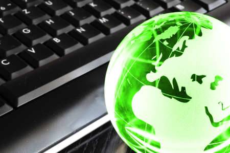 globalisation concept with glass planet on computer keyboard and copyspaceの写真素材