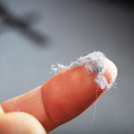 dirt dirty or dust concept with finger showing home cleaningの写真素材