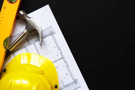 real estate concept with hard hat blueprints tools and copyspaceの写真素材