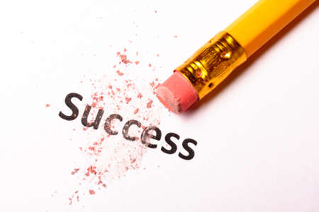 success or failure concept with word and eraser on whiteの写真素材