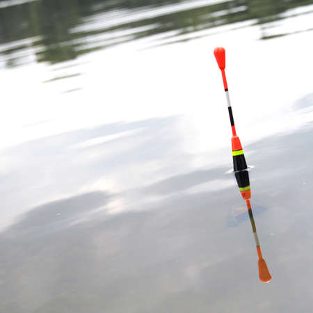 bobber or fishing float in water showing success conceptの写真素材