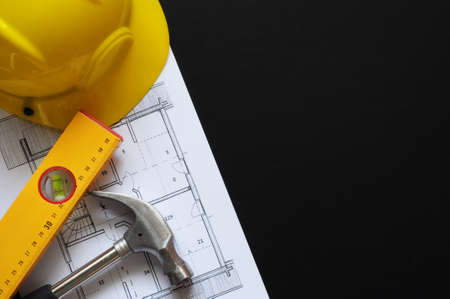 real estate concept with hard hat blueprints tools and copyspaceの写真素材