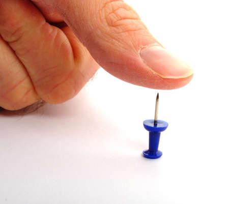 risk concept with finger over risky pinの写真素材