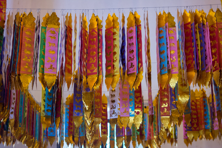 Decorate Flag in the temple, Flag of the Lanna Thai in jedrin temple at ChiangMai top north Thailand. Image blurred from reflection of object lightの写真素材