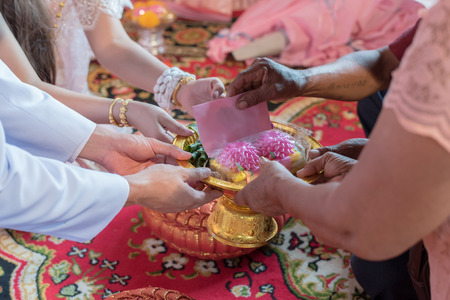 Thai Wedding Traditional. Bride and Groom have to pay respect their parents and they will send packet to newlywed  in wedding ceremony. Send pockets of money in tray. select focusの写真素材