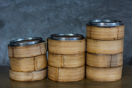 Steamed dim sum and steamed secondary container in gray wall background.の写真素材