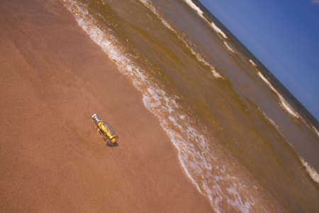 Beach compositions. Botlle brought by the waterの写真素材