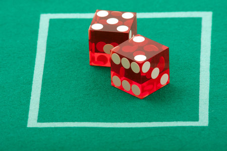 Pair of dice on green casino table felt, 7 rolled