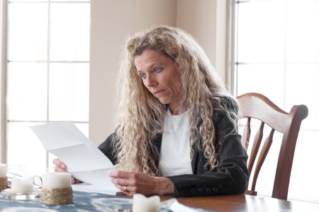 woman worried about bills and debt and foreclosureの写真素材
