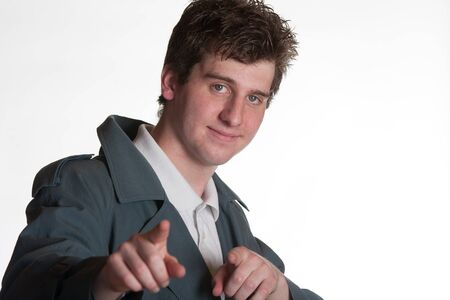 young man in trench coat and polo shirtの写真素材