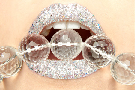 Mouth with Pearl Necklace between her teeth