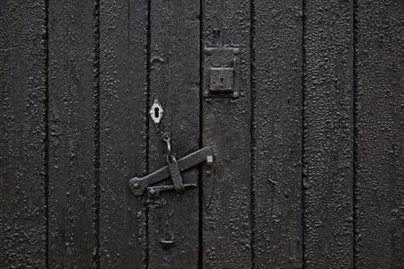 Board wall made of black tarred wood