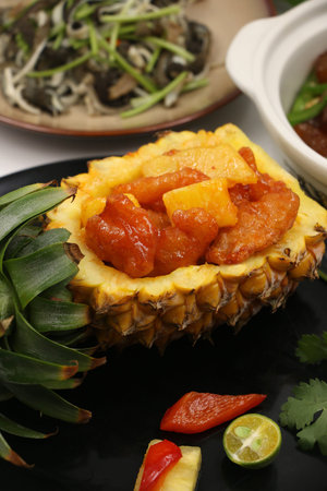 Sweet and sour pork in pineappleの写真素材