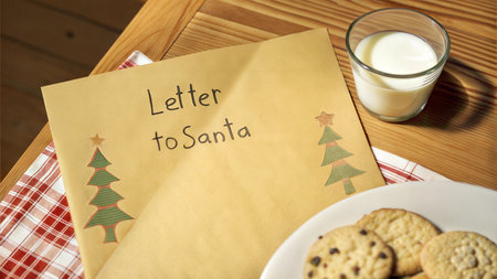 A festive scene with a handwritten letter to Santa Claus, cookies, and a glass of milk.の写真素材