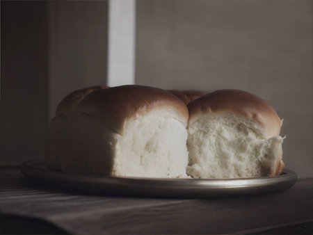 A close-up shot of a freshly baked brioche, showing its golden crust and soft texture.
