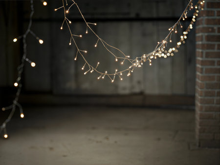 Close-up of fairy lights on a dark background, creating a warm and magical ambiance. Perfect for holiday or celebration themes.の写真素材