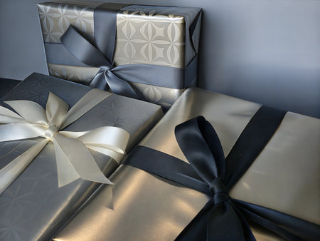 Close-up shot of beautifully wrapped gift boxes tied with elegant ribbons, perfect for holidays or special occasions.の写真素材