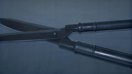 Close-up view of a pair of black metal gardening shears against a dark-blue background.