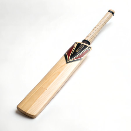Close-up view of a cricket bat, showcasing its wooden construction and grip. The bat is placed on a white background, making it the focal point of the image.の写真素材