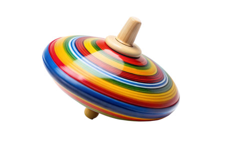A vibrant, rainbow-colored spinning top isolated on a black background.  Classic children's toy.