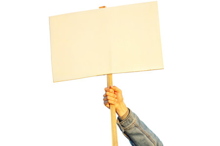 Close-up of a hand holding a blank sign, ideal for adding your own message.  The background is black.の写真素材